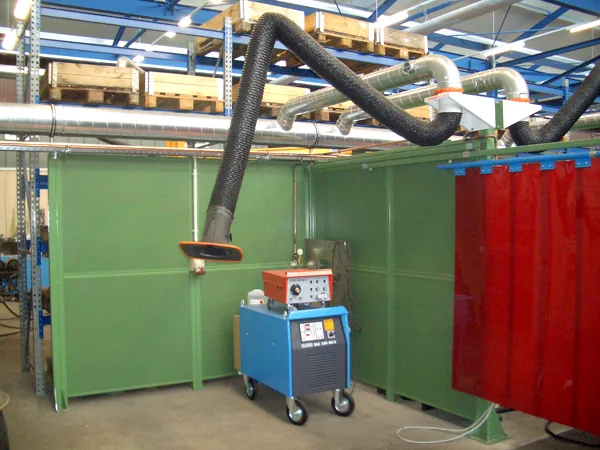 KEMPER fume extraction arms over a welding bay